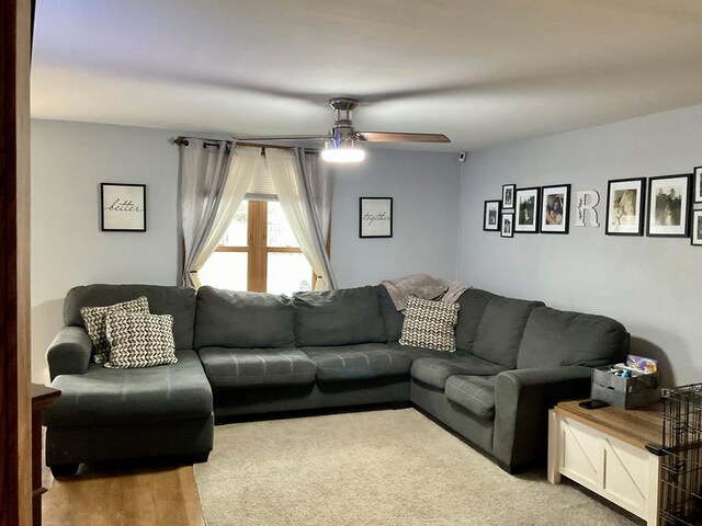 living room with hardwood / wood-style floors and ceiling fan