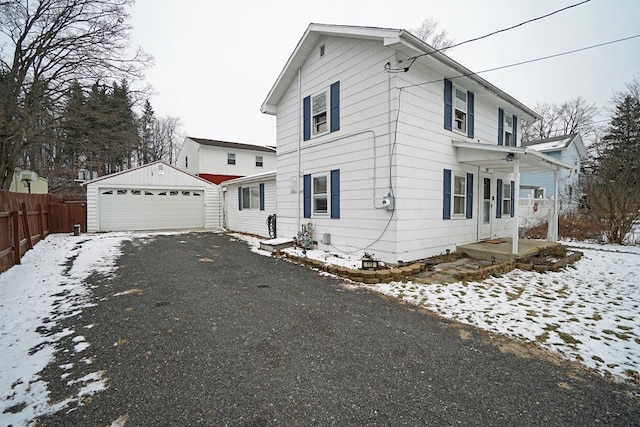 view of front of house featuring a garage and an outdoor structure