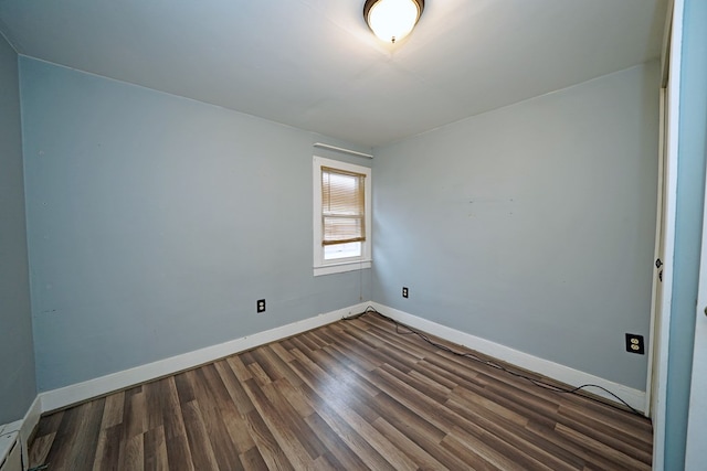 spare room featuring dark hardwood / wood-style flooring