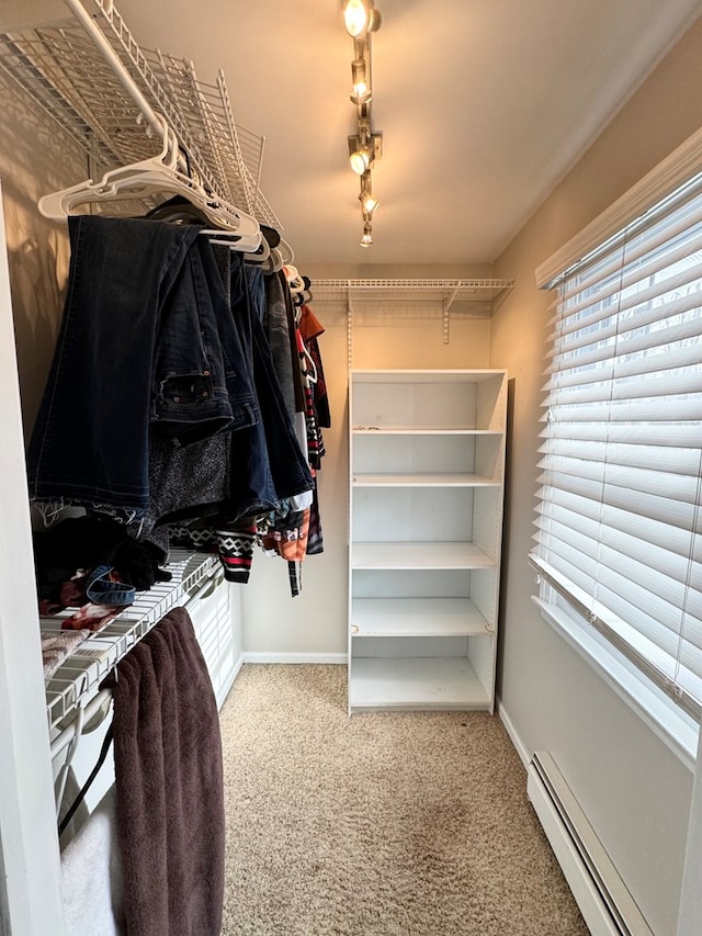 spacious closet with carpet flooring and a baseboard radiator