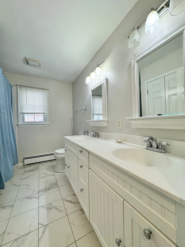 bathroom featuring a baseboard radiator, toilet, and vanity