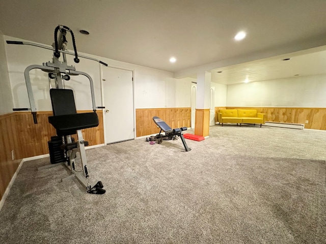 exercise area with carpet floors and a baseboard heating unit