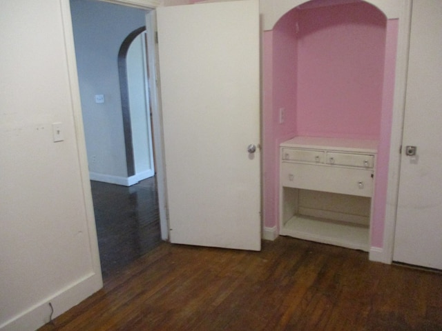 corridor featuring dark hardwood / wood-style flooring