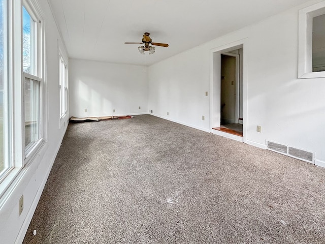 unfurnished room featuring ceiling fan and carpet flooring