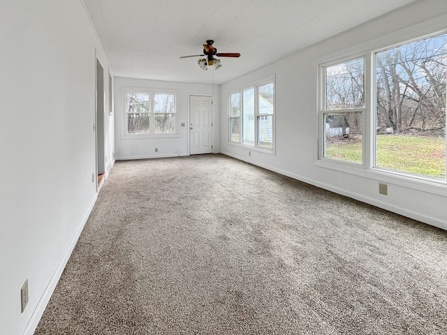 unfurnished sunroom featuring ceiling fan