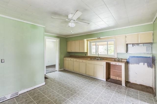 kitchen featuring visible vents, cream cabinets, light countertops, light floors, and a sink