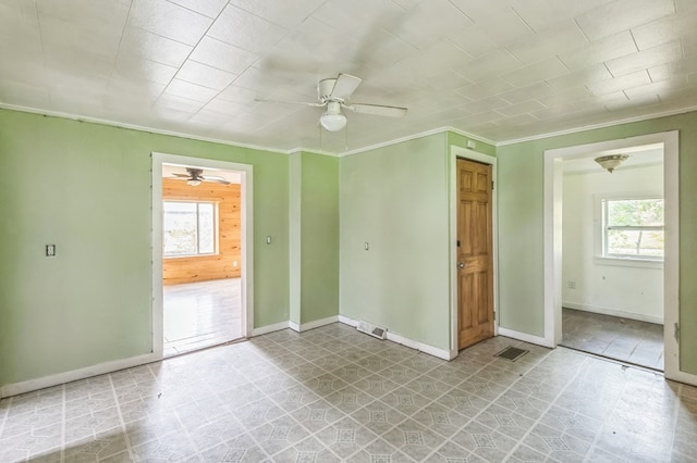 unfurnished room with light floors, baseboards, and ornamental molding