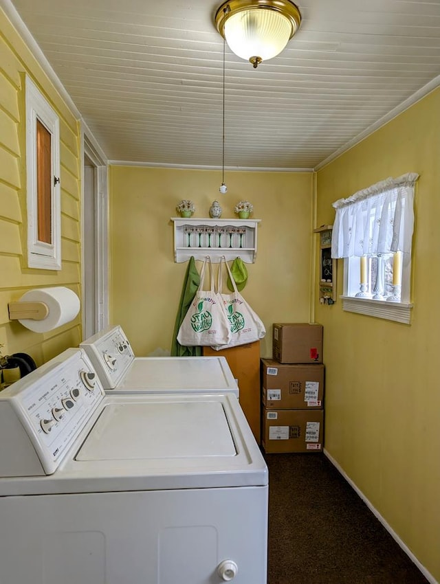 laundry area featuring carpet flooring, washing machine and dryer, and crown molding