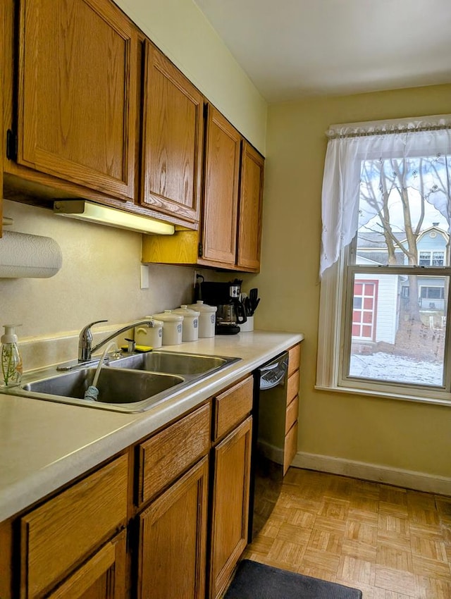 kitchen with sink, light parquet floors, and black dishwasher