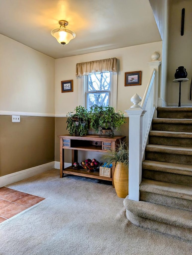 foyer entrance with carpet