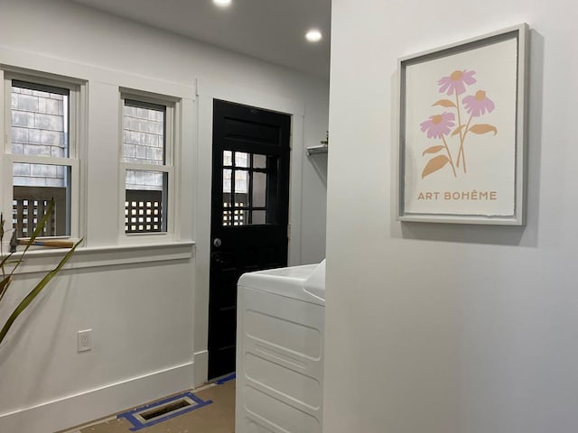 clothes washing area with washer / dryer