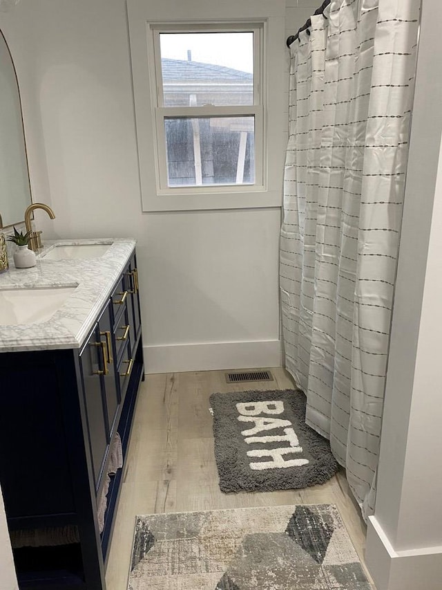 bathroom with vanity and wood-type flooring