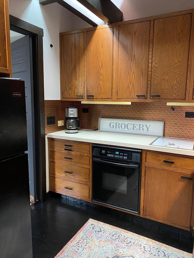 kitchen featuring black appliances and backsplash