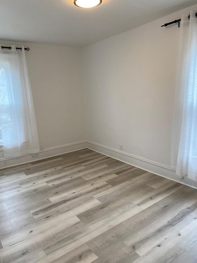 spare room with light hardwood / wood-style flooring