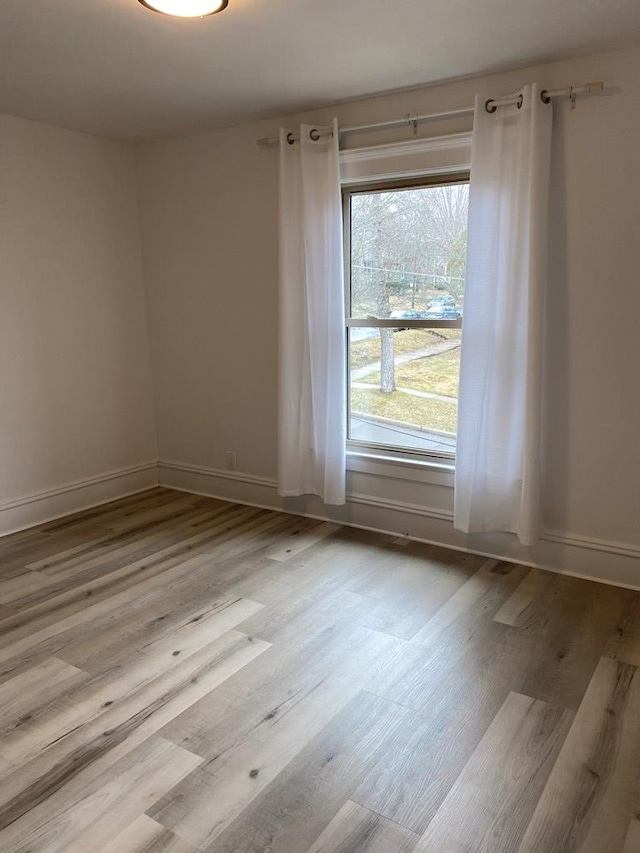 unfurnished room with light hardwood / wood-style floors