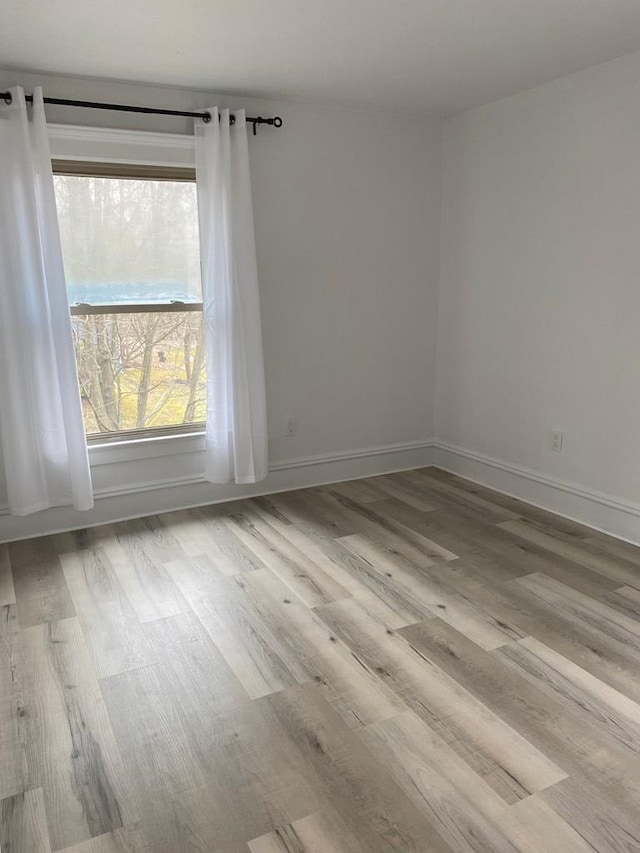 spare room featuring light hardwood / wood-style floors