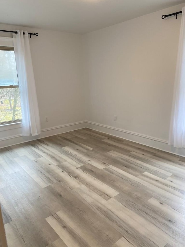 spare room with light wood-type flooring