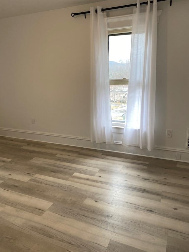 unfurnished room featuring light wood-type flooring