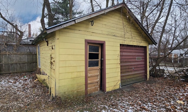 snow covered structure with a garage