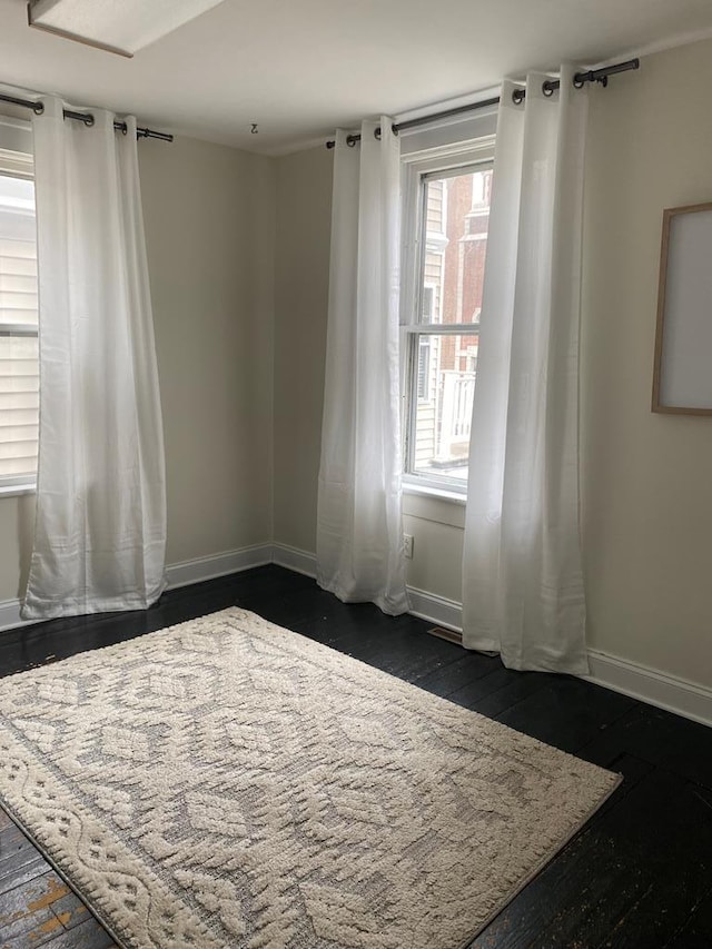 unfurnished bedroom with dark hardwood / wood-style flooring