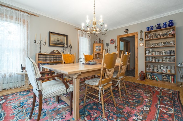 dining area featuring a chandelier, crown molding, and wood-type flooring