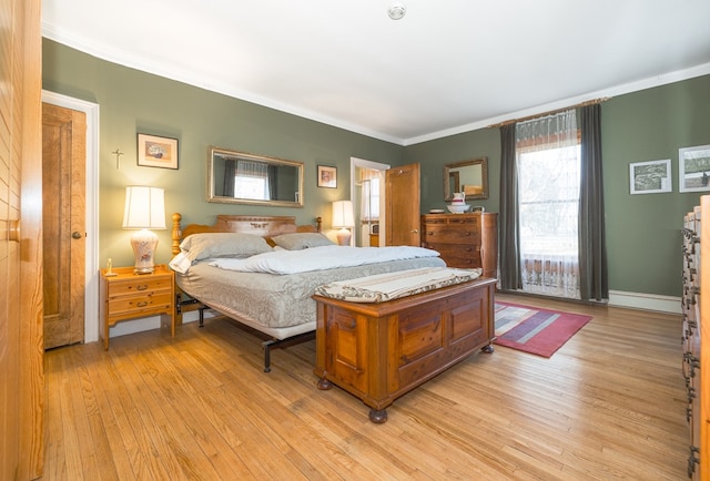 bedroom featuring light hardwood / wood-style floors and ornamental molding