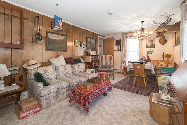 living room with ornamental molding, light colored carpet, an inviting chandelier, and wooden walls