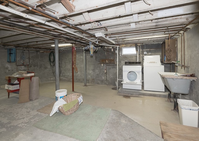 basement featuring washer and dryer and sink