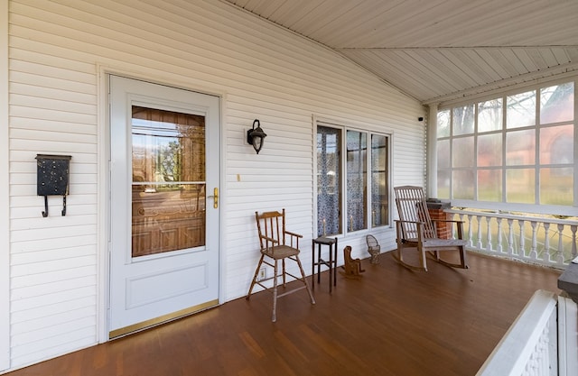 sunroom featuring plenty of natural light and vaulted ceiling