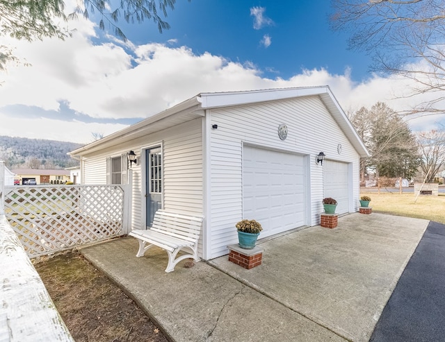 view of side of property featuring an outbuilding and a garage