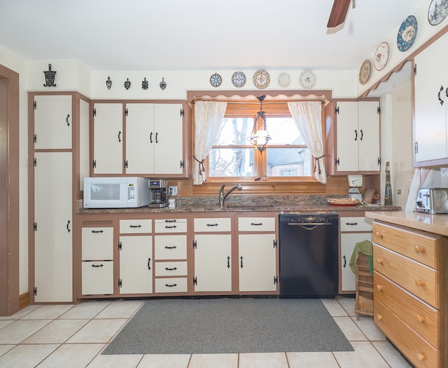 kitchen with ceiling fan, white cabinetry, sink, black dishwasher, and light tile patterned floors