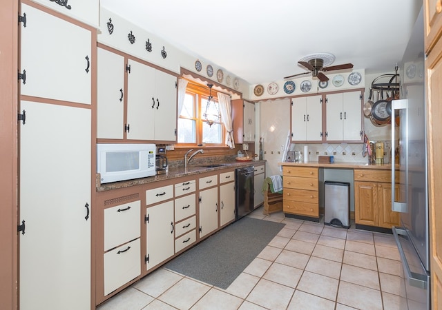 kitchen with backsplash, white cabinets, ceiling fan, light tile patterned floors, and black dishwasher