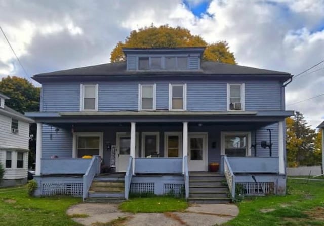 view of front property with a porch and a front lawn