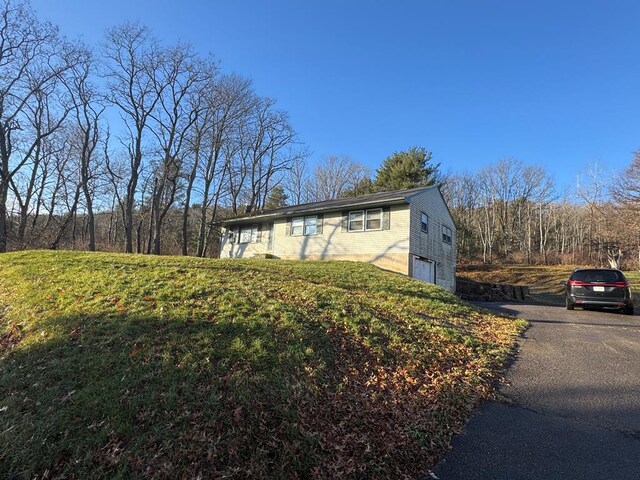 view of side of property with a garage and a yard