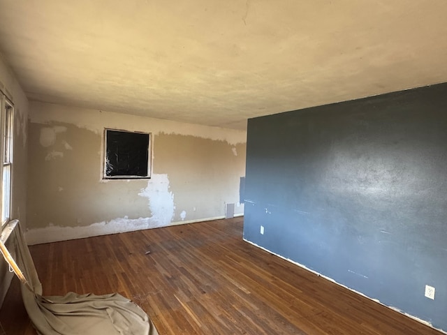 spare room featuring wood-type flooring