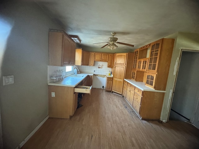 kitchen with sink, backsplash, light hardwood / wood-style floors, and ceiling fan