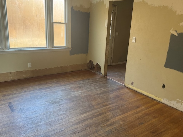 empty room featuring dark hardwood / wood-style flooring