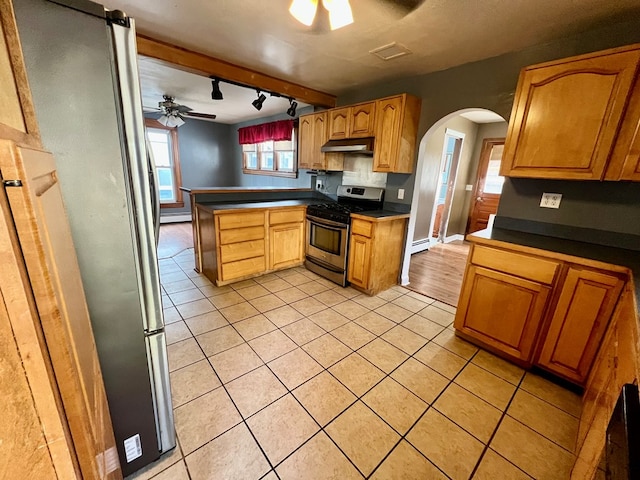 kitchen featuring light tile patterned floors, ceiling fan, kitchen peninsula, stainless steel appliances, and track lighting