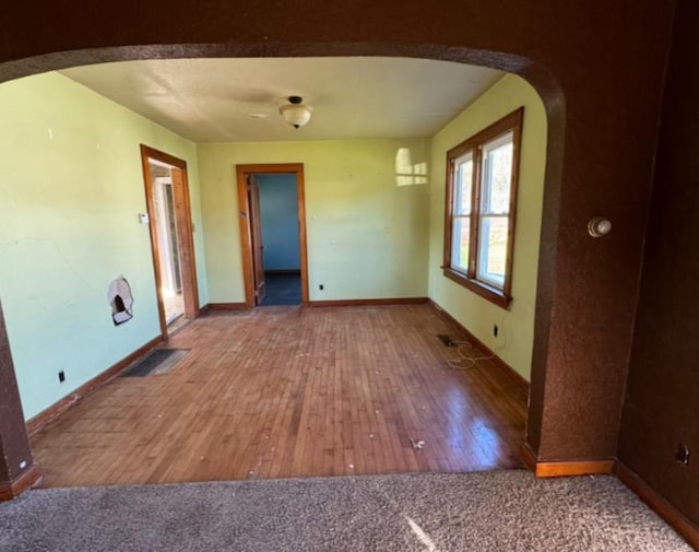 spare room featuring wood-type flooring