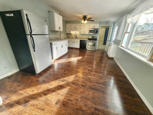 kitchen featuring white cabinetry, sink, dark wood-type flooring, and stainless steel appliances