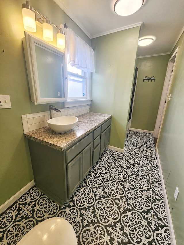 bathroom featuring tasteful backsplash, tile patterned flooring, vanity, toilet, and crown molding