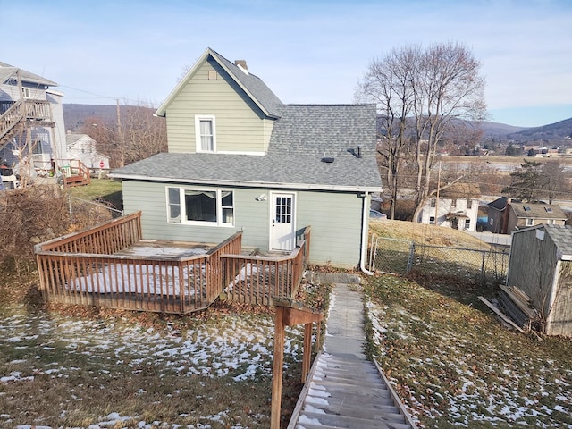 back of property with a wooden deck