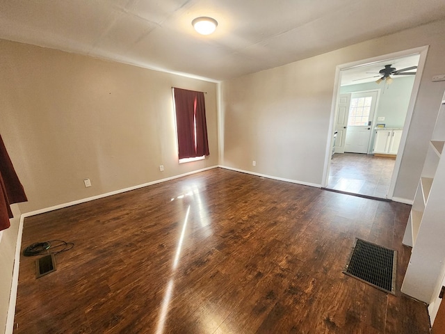 unfurnished room with dark hardwood / wood-style floors and ceiling fan