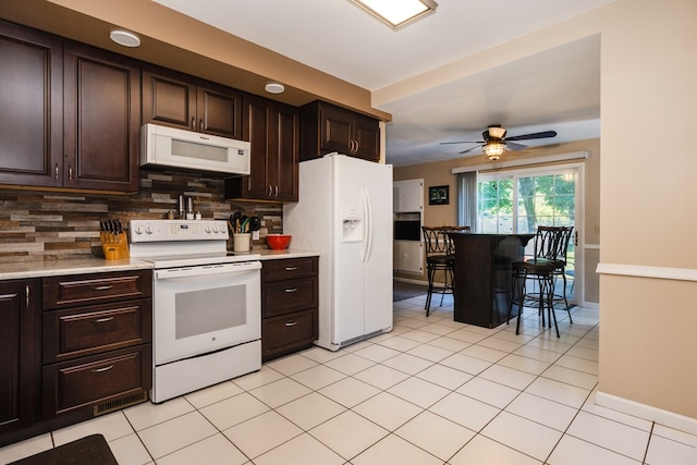 kitchen featuring white appliances, ceiling fan, tasteful backsplash, and dark brown cabinetry