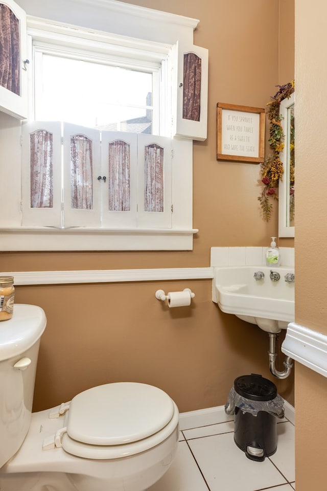 bathroom featuring toilet, tile patterned flooring, and sink