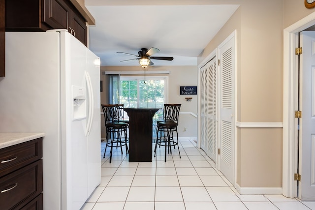 tiled dining area featuring ceiling fan