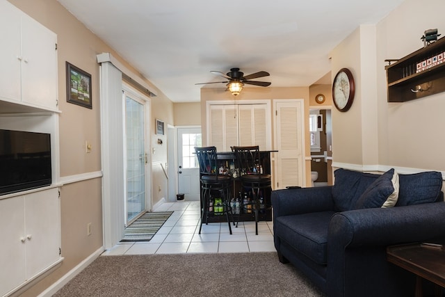 tiled living room with ceiling fan