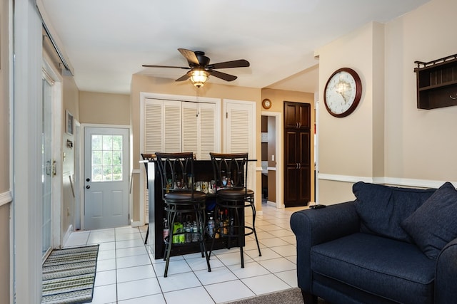 living room with ceiling fan and light tile patterned floors