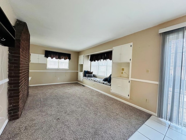 unfurnished living room featuring light carpet