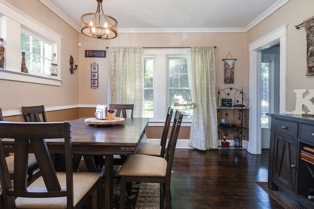 dining space featuring dark wood-type flooring, crown molding, and a chandelier